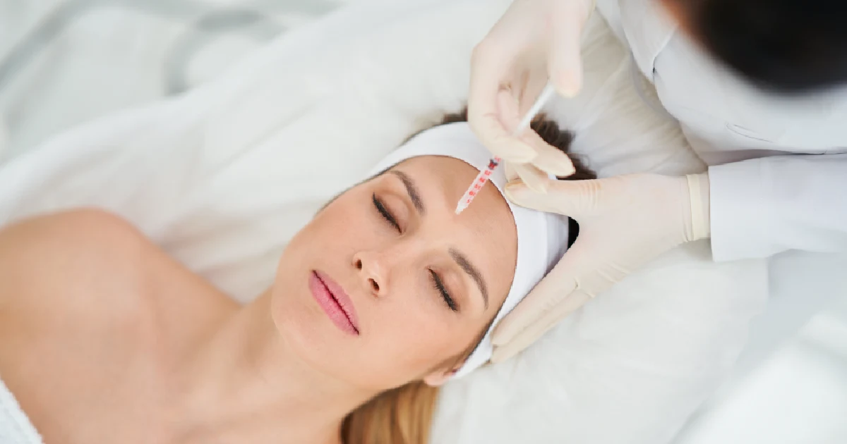 A woman receiving a Dysport injection in the forehead in Denver, CO